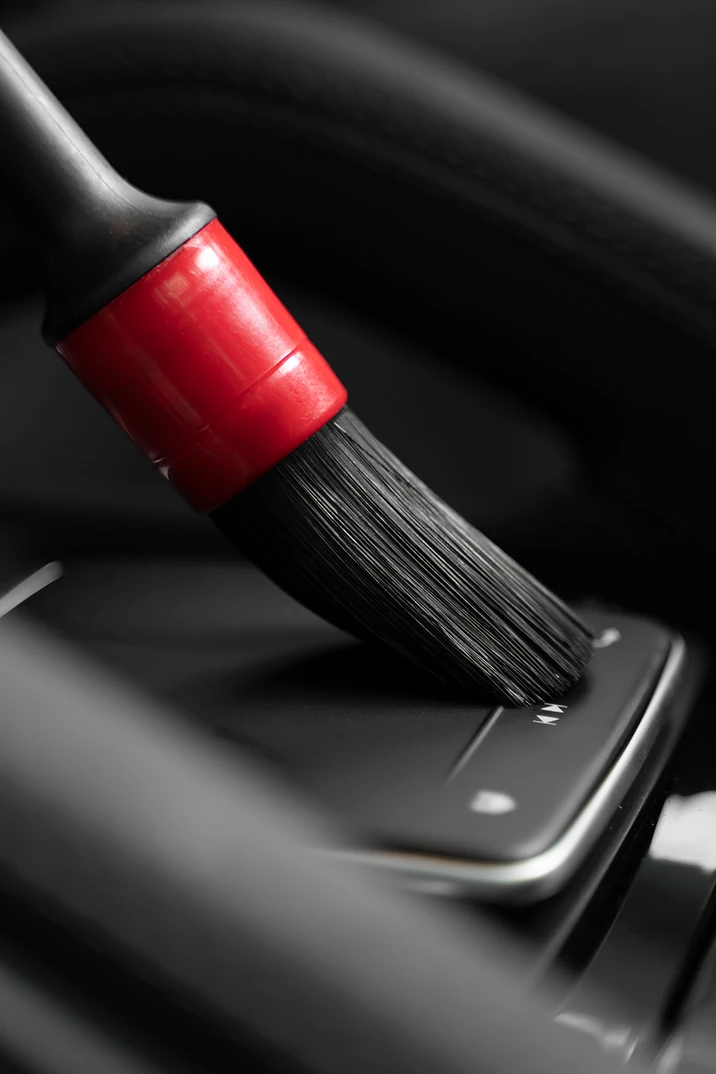 Detailing brush cleaning a car interior